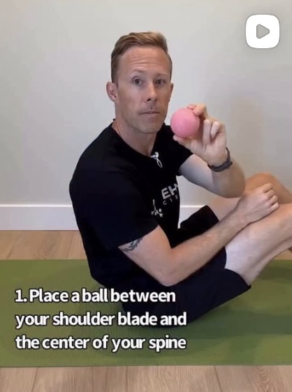Mobility coach demonstrating a shoulder release exercise